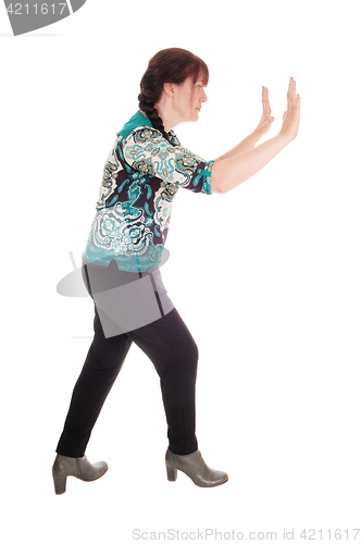 Image of Woman pushing something away.