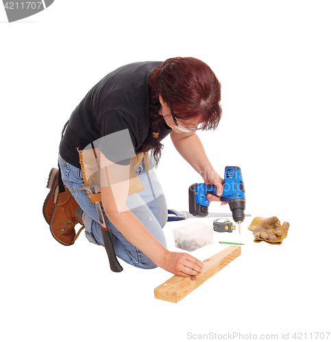 Image of Woman working with tools.