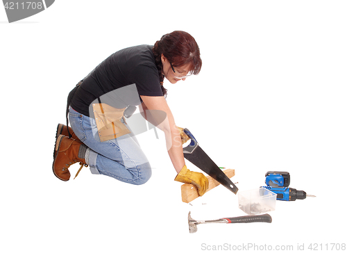 Image of Woman working with her saw.