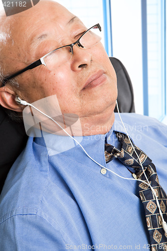 Image of Relaxed senior asian businessman