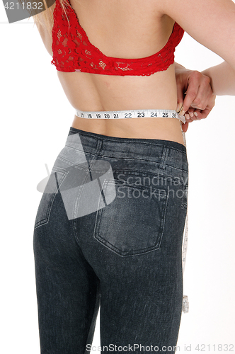 Image of Woman measuring her waist.