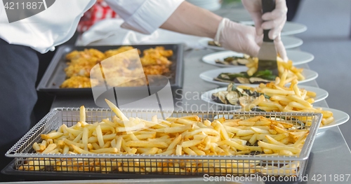 Image of French fries and meat on the table