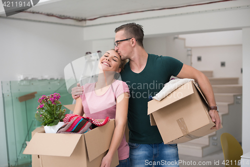 Image of young couple moving into a new home