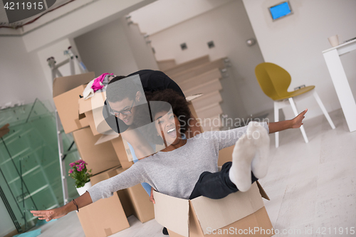 Image of African American couple  playing with packing material