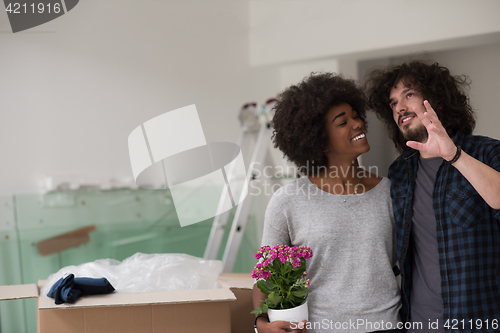 Image of multiethnic couple moving into a new home