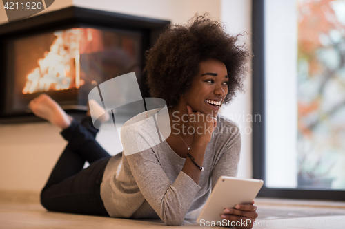Image of black women using tablet computer on the floor