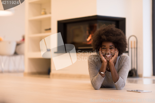 Image of black women using tablet computer on the floor