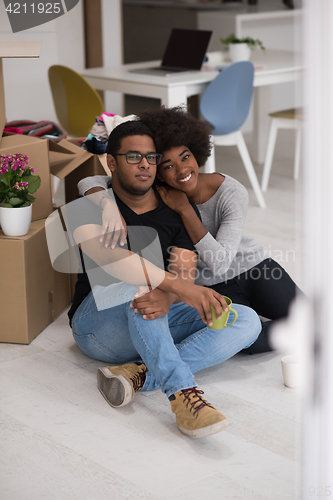 Image of African American couple relaxing in new house