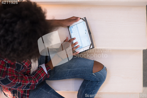 Image of black woman using her electronic tablet