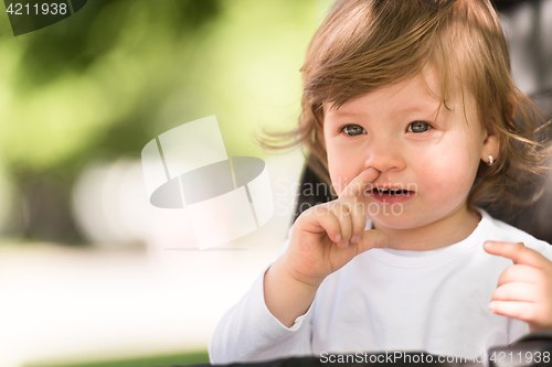 Image of baby girl sitting in the pram