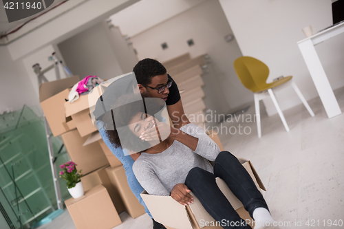 Image of African American couple  playing with packing material