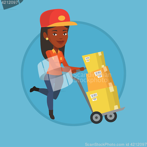 Image of Delivery postman with cardboard boxes on trolley.