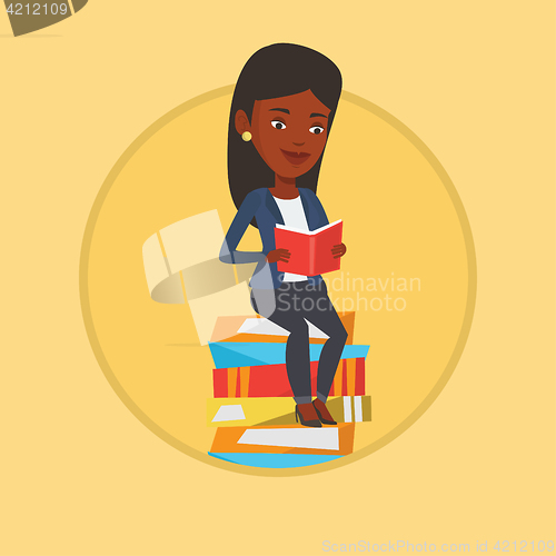 Image of Student sitting on huge pile of books.