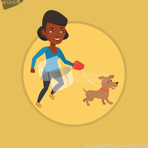 Image of Young woman walking with her dog.