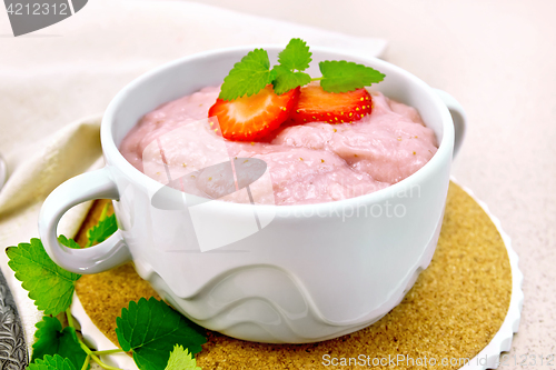 Image of Soup strawberry in bowl with mint on stone table