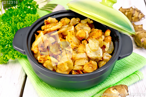 Image of Jerusalem artichoke roasted in brazier on light board