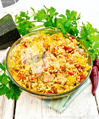 Image of Rice with chicken and zucchini in pan on light board