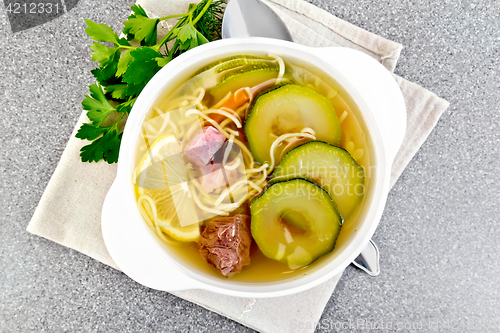 Image of Soup with zucchini and noodles on granite table top