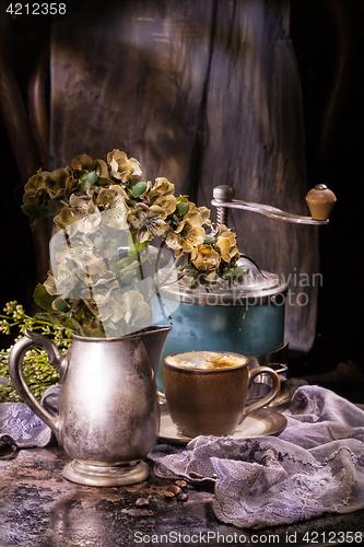 Image of Flowes And Old Coffee Mill
