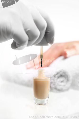 Image of Beautician painting nails Painting nail varnish color