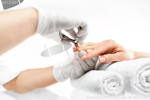 Image of Manicure, cutting skins woman to a beautician