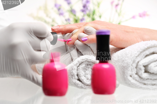 Image of Hybrid manicure, beauty salon Styling nail color nail polish Beautician painting nailsStyling nail color nail polish Pastel nails pink nail polish