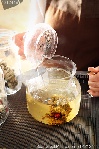 Image of Blooming tea brewed in a glass jug. Blooming tea.