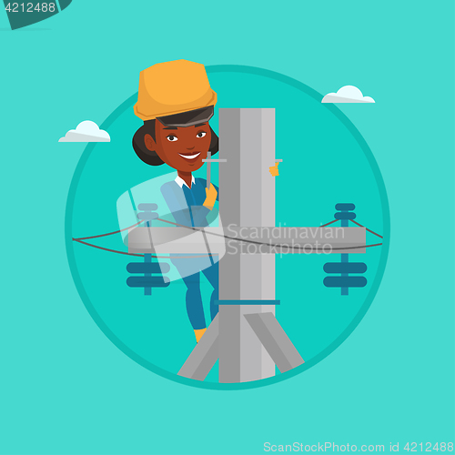 Image of Electrician working on electric power pole.