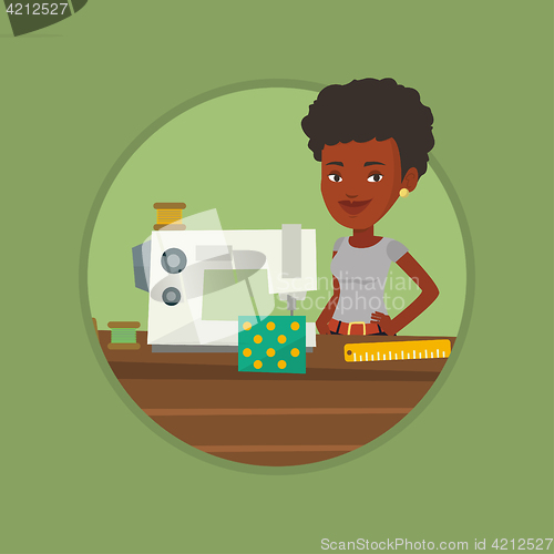 Image of Seamstress using sewing machine at workshop.