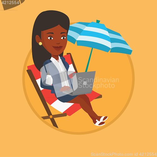 Image of Businesswoman working on laptop at the beach.