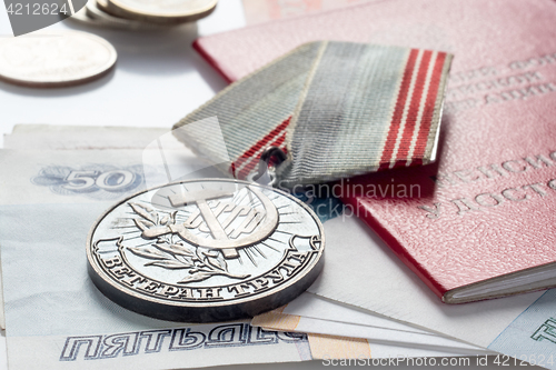 Image of Veteran&#39;s medal of labor, pension certificate and money