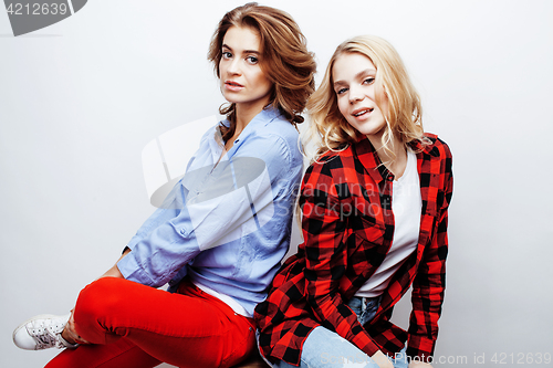 Image of two pretty blond woman having fun together on white background, mature mother and young teenage daughter, lifestyle people concept