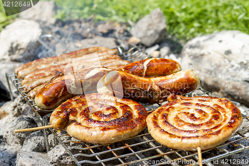 Image of sausages on grill outdoor