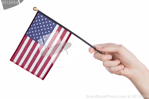 Image of Hand holding american flag on white