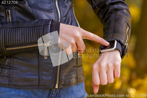 Image of Teenager girl Using touchscreen smart watch