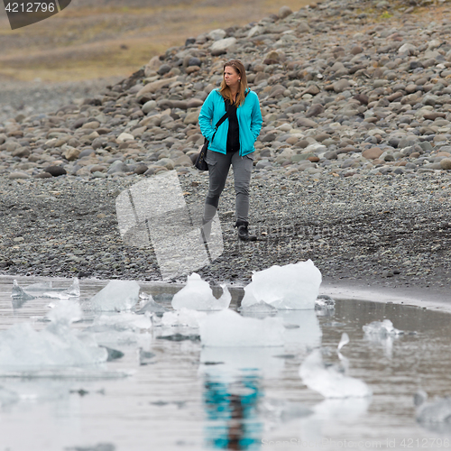 Image of Woman walking over the beach at Jokulsarlon glacier lagoon - Ice