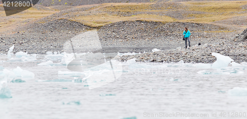 Image of Woman walking over the beach at Jokulsarlon glacier lagoon - Ice