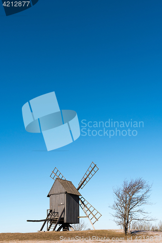 Image of Old wooden windmill on a hill