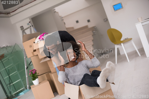 Image of African American couple  playing with packing material