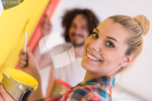 Image of couple painting interior wall