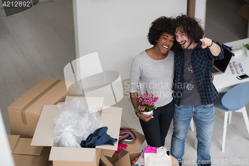 Image of multiethnic couple moving into a new home