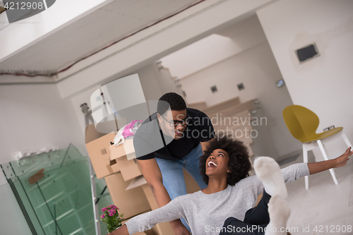 Image of African American couple  playing with packing material