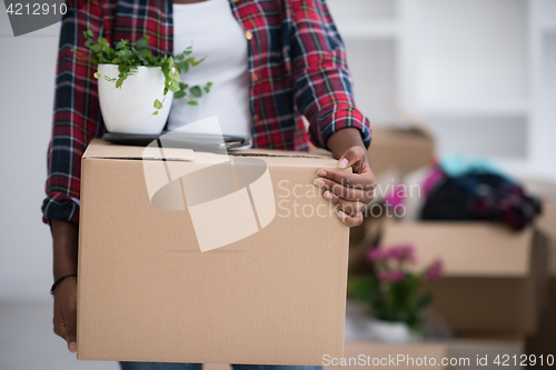 Image of Black girl moving in the new apartment