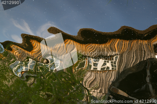 Image of Reflection of a wooden house at the ecomusee in Alsace