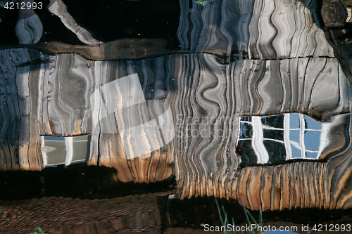 Image of Reflection of a wooden house at the ecomusee in Alsace