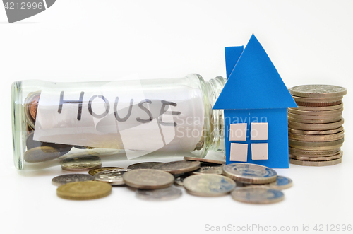 Image of House model and stacks of coins