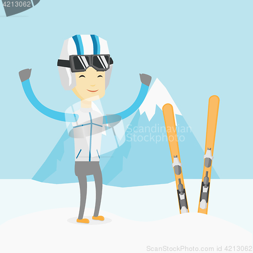 Image of Cheerful skier standing with raised hands.