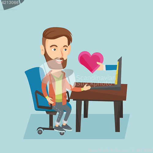 Image of Young man dating online using laptop.