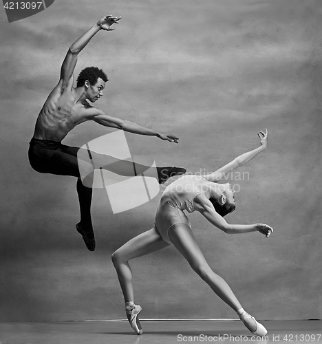 Image of Couple of ballet dancers posing over gray background