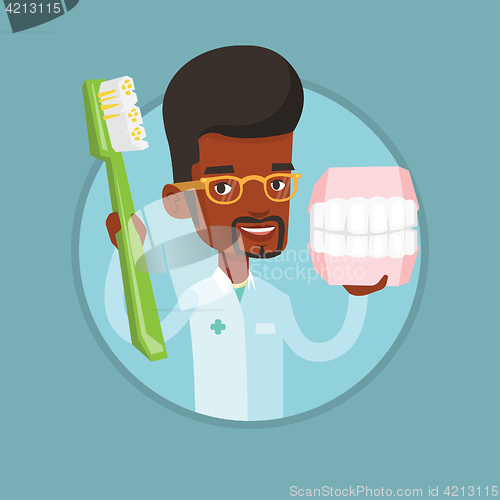 Image of Dentist with dental jaw model and toothbrush.